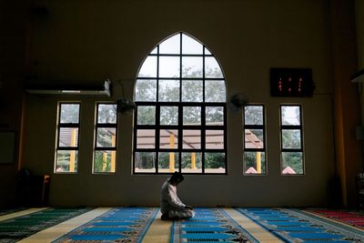 A man praying inside mosque 