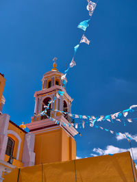 Low angle view of traditional building against blue sky