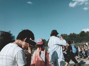 People standing against clear sky