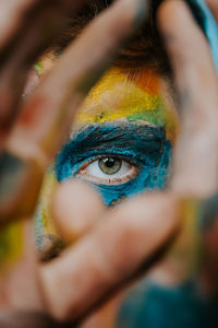 Close-up portrait of a young boy with multi colored face