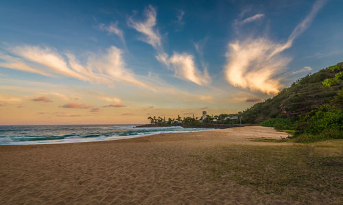 Scenic view of beach against sky during sunset