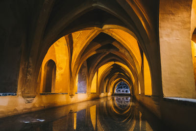 Illuminated building seen through wet glass