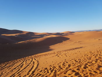 Scenic view of desert against clear sky