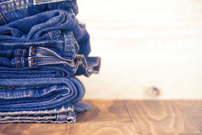 Close-up of stacked jeans on table