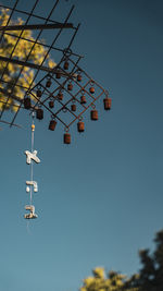 Low angle view of wind turbine against clear blue sky