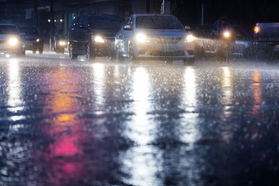 Wet street in city during rainy season at night