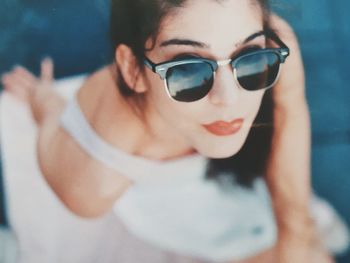 Close-up portrait of young woman wearing sunglasses