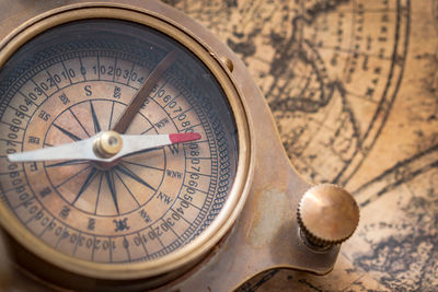 Close-up of navigational compass on map