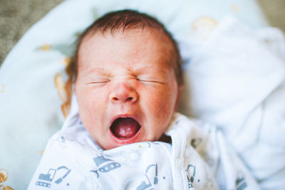 Close-up of baby boy sleeping in bed