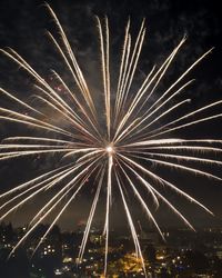 Low angle view of firework display at night