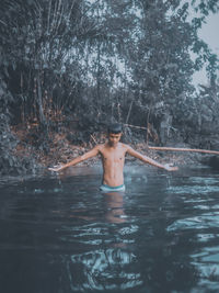 Full length of shirtless man in water