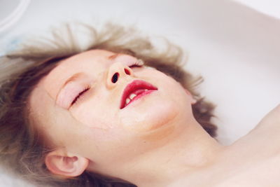 Close-up of boy relaxing in bathtub