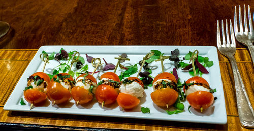 High angle view of fruits in plate on table