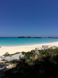 Scenic view of sea against clear blue sky