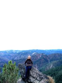 Man standing on mountain against sky