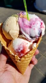 Close-up of hand holding ice cream