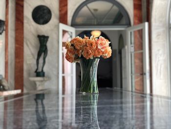 Close-up of rose in glass vase on table