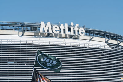 Low angle view of text on building against sky