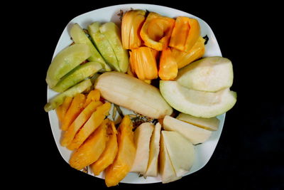 Close-up of fruit over black background