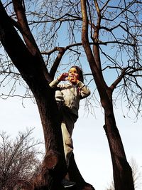 Low angle view of bare tree against sky