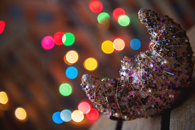 Close-up of illuminated christmas ornament on table