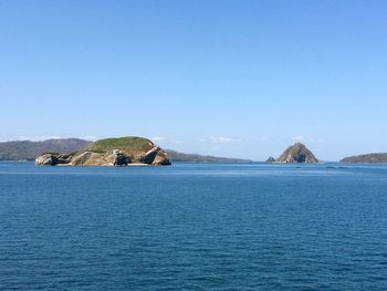 Scenic view of sea against clear blue sky