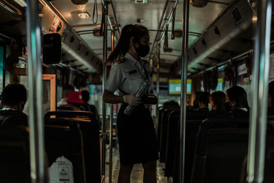 Rear view of people sitting in train