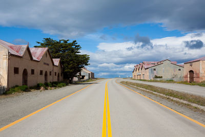 Surface level of road by buildings against sky