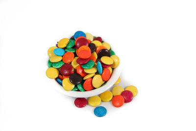 Close-up of multi colored candies against white background