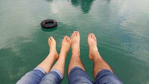 Low section of people relaxing over sea