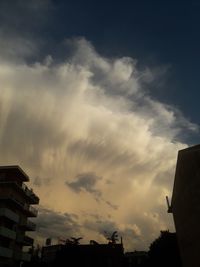 Low angle view of silhouette buildings against sky