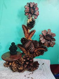 Close-up of wilted plant on table against wall