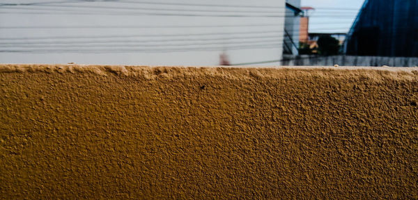 Close-up of barn on sand against wall