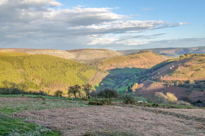 Scenic view of landscape against cloudy sky