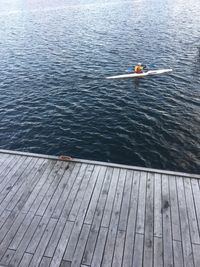 High angle view of person sitting on lake