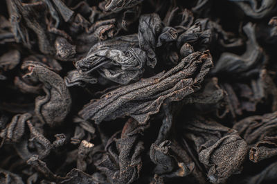 Close-up. black loose leaf tea as a background. texture of dry black tea leaves. dark background