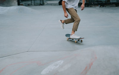 Low section of man skateboarding on skateboard