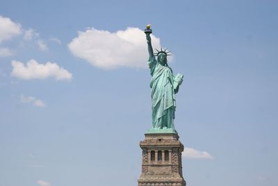 Low angle view of statue against cloudy sky