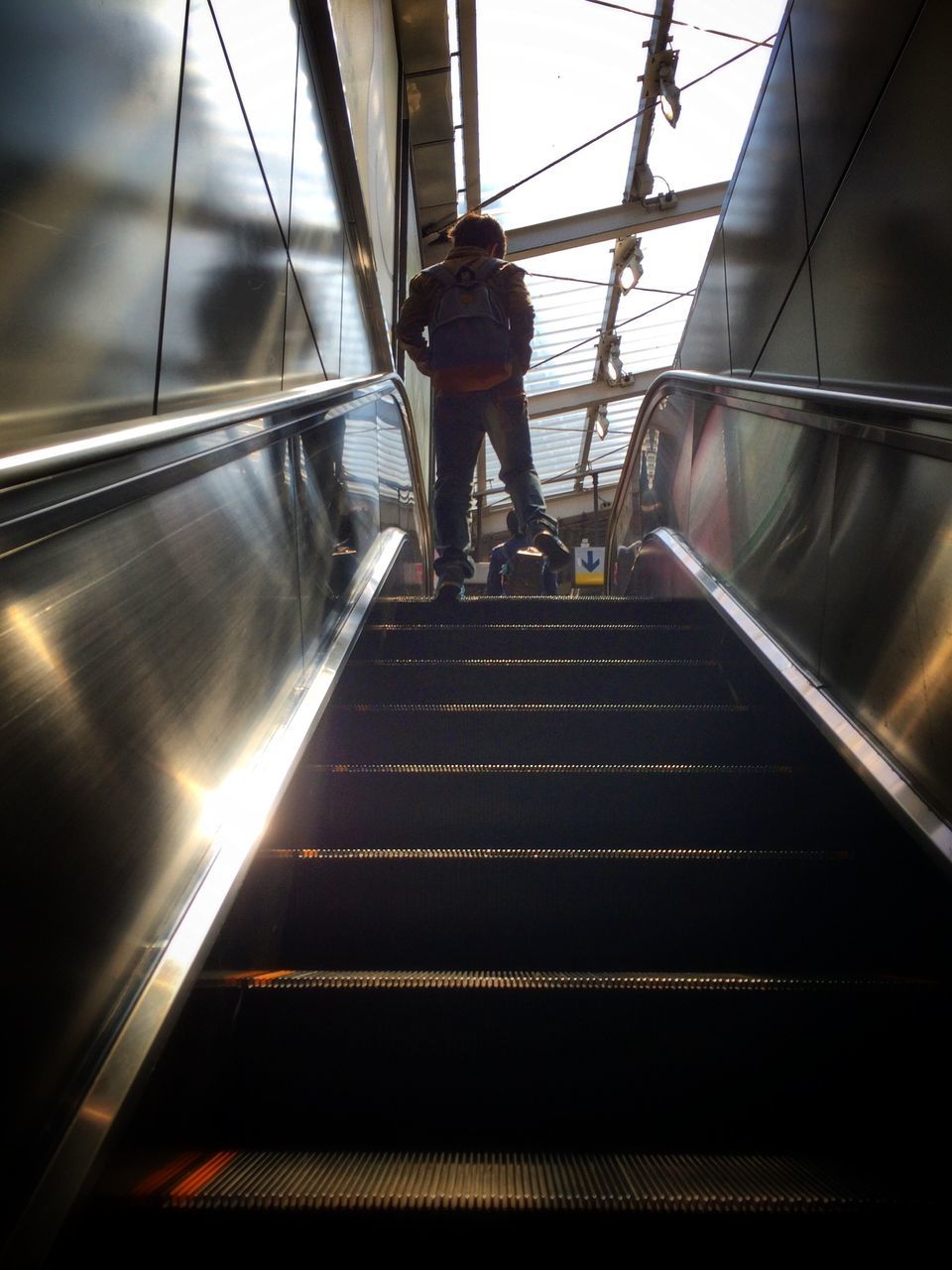 indoors, low angle view, escalator, steps and staircases, steps, staircase, railing, the way forward, technology, built structure, architecture, illuminated, diminishing perspective, modern, ceiling, moving up, men, lighting equipment, convenience