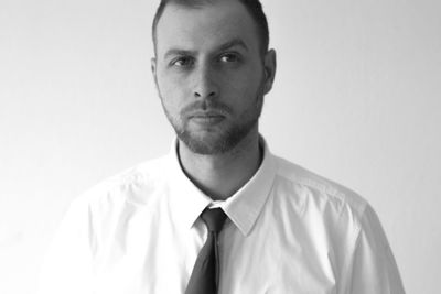 Portrait of young man against white background