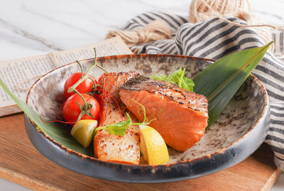 High angle view of grilled salmon in plate on table