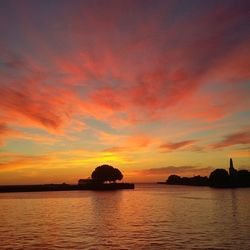 Scenic view of sea against orange sky