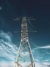 Low angle view of electricity pylon against sky