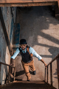 Portrait of smiling man standing against built structure