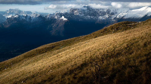 Scenic view of snowcapped mountains against sky. dry meadow. nevegal, belluno, italy