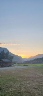 Scenic view of field against sky during sunset