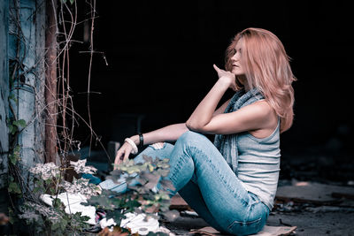 Beautiful young looking away woman sitting outdoors