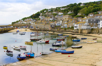 Boats moored at harbor