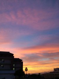 Low angle view of building against sky at sunset