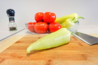 Green pepper on wooden plate